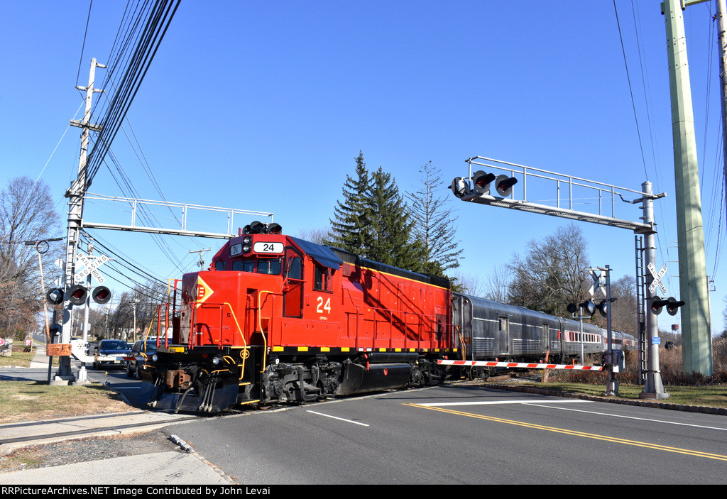 The 24 shoving the Polar Express train across S. Jefferson Road back toward the Whippany Railway Museum